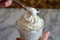 hand with spoon taking a dollop of whipped cream