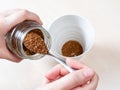 Hand spooning up second portion of instant coffee Royalty Free Stock Photo