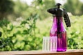 Hand sprayer on the wooden background in the garden