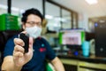 Hand is spraying alcohol with blurry businessman working in office Royalty Free Stock Photo