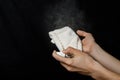 Hand sprays a disinfectant on a rag