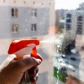 hand sprays washing liquid on window glass closeup Royalty Free Stock Photo