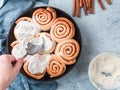 Hand Spreading Frosting on Cinnamon Rolls, copy space