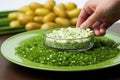 hand sprouting chives over a serving platter of potato salad Royalty Free Stock Photo