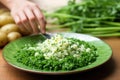 hand sprouting chives over a serving platter of potato salad Royalty Free Stock Photo