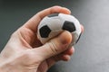 Hand squeezes a small soccer ball.