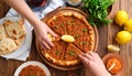 Traditional delicious Turkish foods Turkish Lahmacun. top view. The woman squeezes Royalty Free Stock Photo