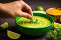 hand squeezing lime slice over ready soup