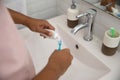 Hand squeezing tooth paste to the brush Royalty Free Stock Photo