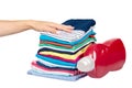 Hand with stack of clothes and detergent bottle, fresh laundry textile Royalty Free Stock Photo