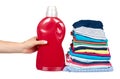 Hand with stack of clothes and detergent bottle, fresh laundry textile Royalty Free Stock Photo