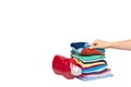 Hand with stack of clothes and detergent bottle, fresh laundry textile Royalty Free Stock Photo