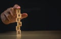 Hand Stacking Blocks Spelling TRENDS. Close-up image of a hand carefully stacking wooden blocks Trends business goal