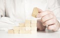 Hand stacking wooden blocks for in shape of staircase. Business development, strategy concept. Building success foundation Royalty Free Stock Photo