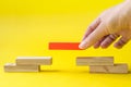 Hand stacking wooden blocks for in shape of staircase, piramid. Business development, strategy concept. Building success Royalty Free Stock Photo