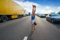 Hand stand girl in a traffic jam road Royalty Free Stock Photo