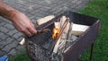 A hand is starting a fire in a grill for barbeque Royalty Free Stock Photo