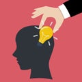 Hand stealing idea light bulb from head Royalty Free Stock Photo