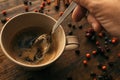 Hand steering coffee in a cup with spoon