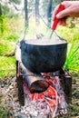 Hand stir the soup in the pot Royalty Free Stock Photo