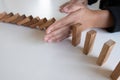 Woman hand stop blocks wood protect other, Concept Prevent failures from spreading to other business