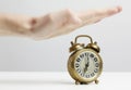 Hand stopping alarm on clock Royalty Free Stock Photo