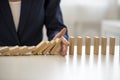 Hand stopping falling blocks on table Royalty Free Stock Photo