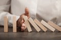 Hand Stops Falling Wooden Domino Blocks, Risk Insurance Concept, Crisis Manager, Domino Principle