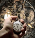 Hand with stopwatch and clockwork inside Royalty Free Stock Photo