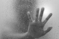 Hand of stranger on frosted glass with water drop