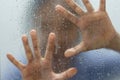 Hand of stranger on frosted glass with water drop