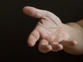 Outstretched hand on a dark background