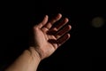 Hand stretching towards the light. Royalty Free Stock Photo