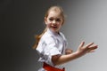 Hand strike in karate, defensive technique. Portrait of a smiling little girl at a sports training