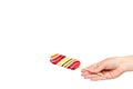 Hand with striped color lollipop, bright cool candy