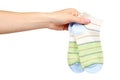 Hand with striped cotton sock, child footwear Royalty Free Stock Photo