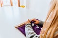 Hand of a student handling montessori material inside a classroom