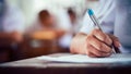 Hand of students taking exam with stress in classroom Royalty Free Stock Photo