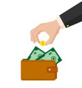 Hand in a suit puts a golden dollar in a purse Royalty Free Stock Photo