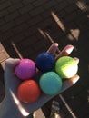 Hand holding colorful golfballs