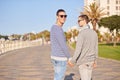 Hand in hand on a sunny day. a young gay couple enjoying a walk on the promenade. Royalty Free Stock Photo