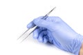 Hand of surgeon in blue medical glove holding a tweezers isolated on white background Royalty Free Stock Photo