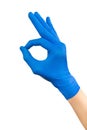 Hand of surgeon in blue medical glove showing Ok sign, isolated on a white background Royalty Free Stock Photo