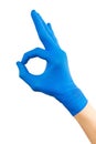 Hand of surgeon in blue medical glove showing Ok sign, isolated on a white background Royalty Free Stock Photo