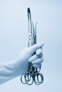 Hand of surgeon with forceps Royalty Free Stock Photo