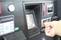 Hand swiping credit card at gas pump station.