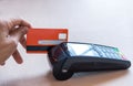 Hand Swiping Credit Card on POS terminal in Store