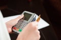 Hand swiping debit card on pos terminal Royalty Free Stock Photo