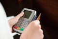 Hand swiping debit card on pos terminal Royalty Free Stock Photo