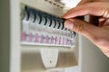 Hand switching power switch on a fusebox. Close up of electrician checking fuse box knob Royalty Free Stock Photo